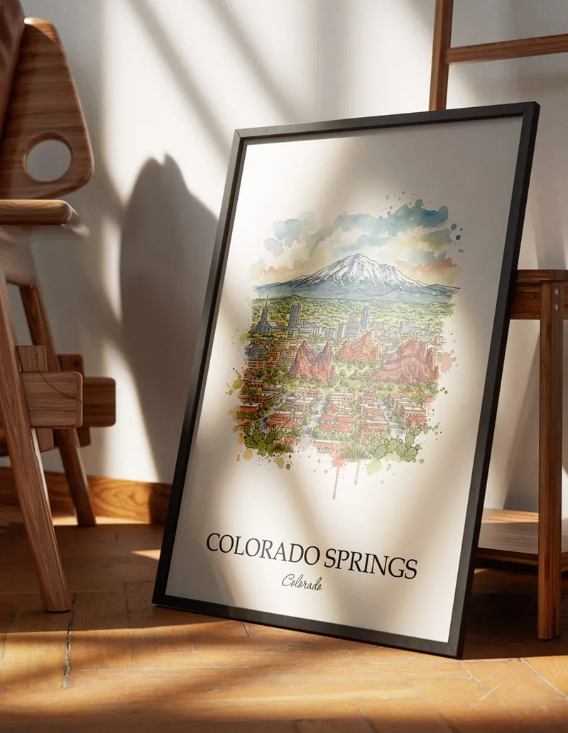 Minimalist poster of Colorado Springs city in USA - Colorado in a light frame standing on the floor in a dark moody interior.