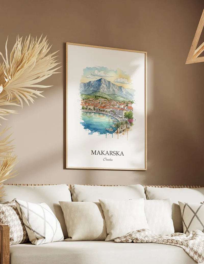Vintage travel poster of Makarska city, Croatia in a light frame displayed above a sofa in a bright boho interior.