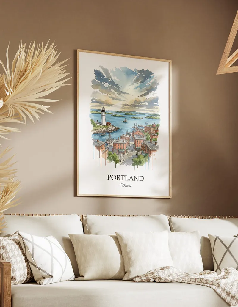 Vintage travel poster of Portland city, USA - Maine in a light frame displayed above a sofa in a bright boho interior.