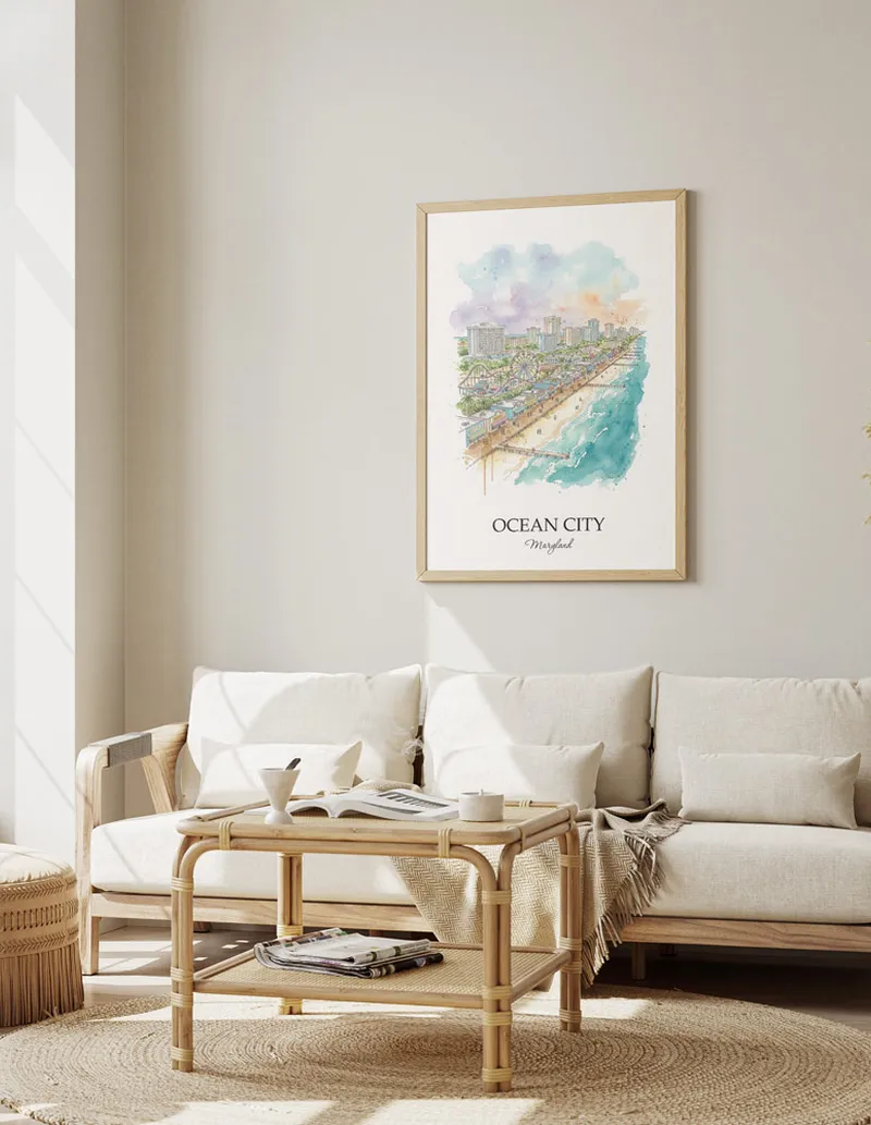 Framed wall art featuring Ocean City, USA - Maryland in a light wood frame hanging above a sofa in a modern living room.