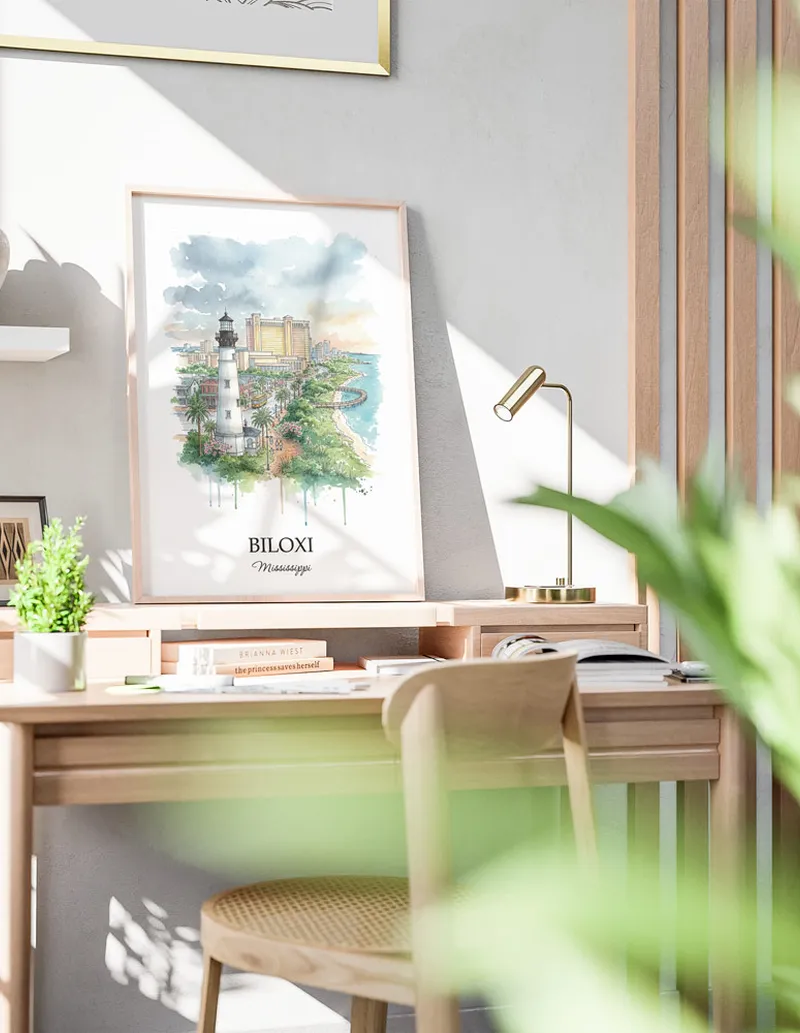 Cozy, well-lit workspace with a minimalist poster of Biloxi, USA - Mississippi in a light frame sitting on the desk.