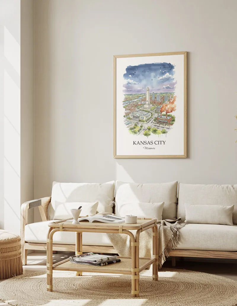 Framed wall art featuring Kansas City, USA - Missouri in a light wood frame hanging above a sofa in a modern living room.