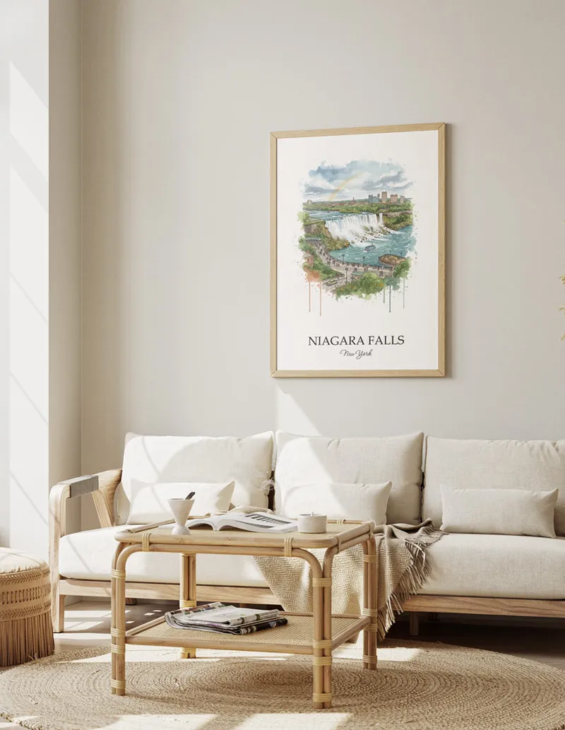 Framed wall art featuring Niagara Falls, USA - New York in a light wood frame hanging above a sofa in a modern living room.
