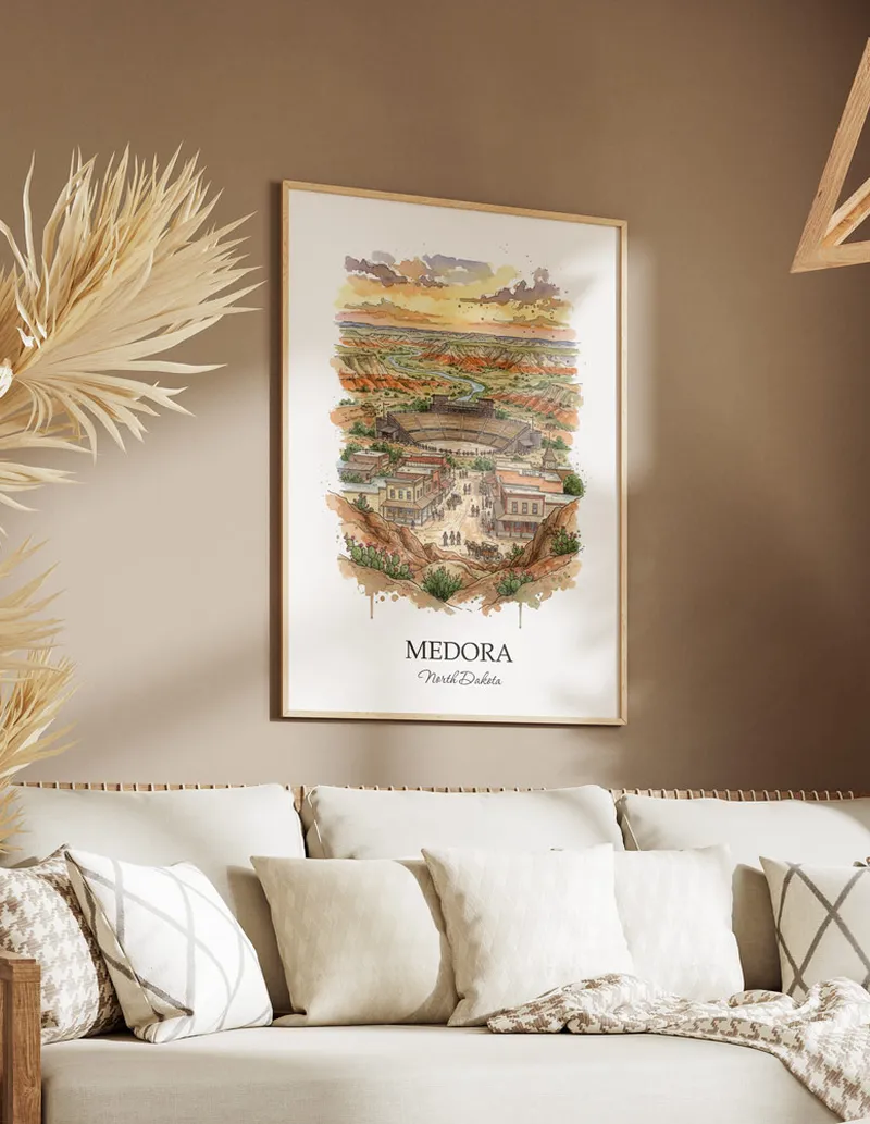 Vintage travel poster of Medora city, USA - North Dakota in a light frame displayed above a sofa in a bright boho interior.