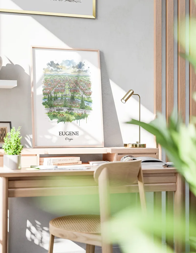Cozy, well-lit workspace with a minimalist poster of Eugene, USA - Oregon in a light frame sitting on the desk.