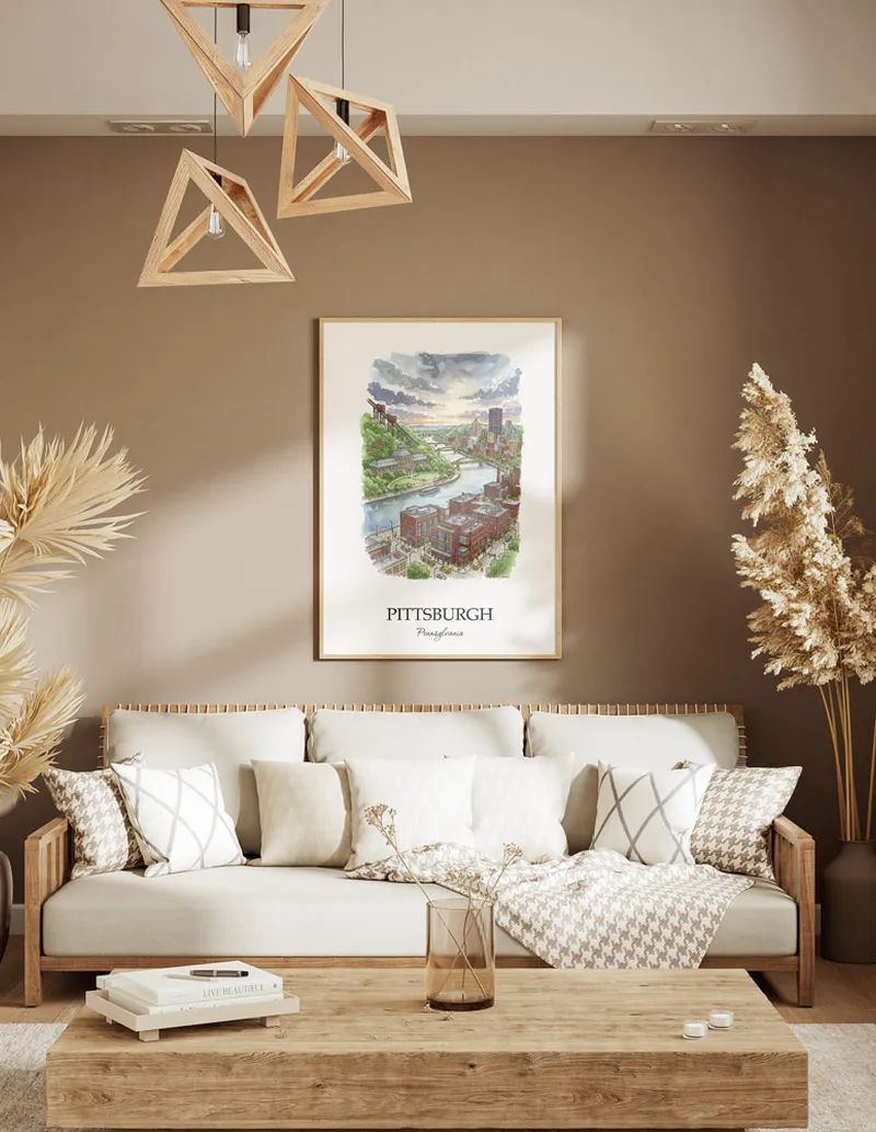 A gorgeous boho-inspired living space with a framed vintage travel poster of Pittsburgh city on display.