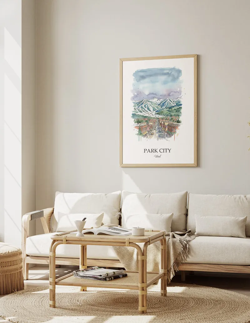 Framed wall art featuring Park City, USA - Utah in a light wood frame hanging above a sofa in a modern living room.