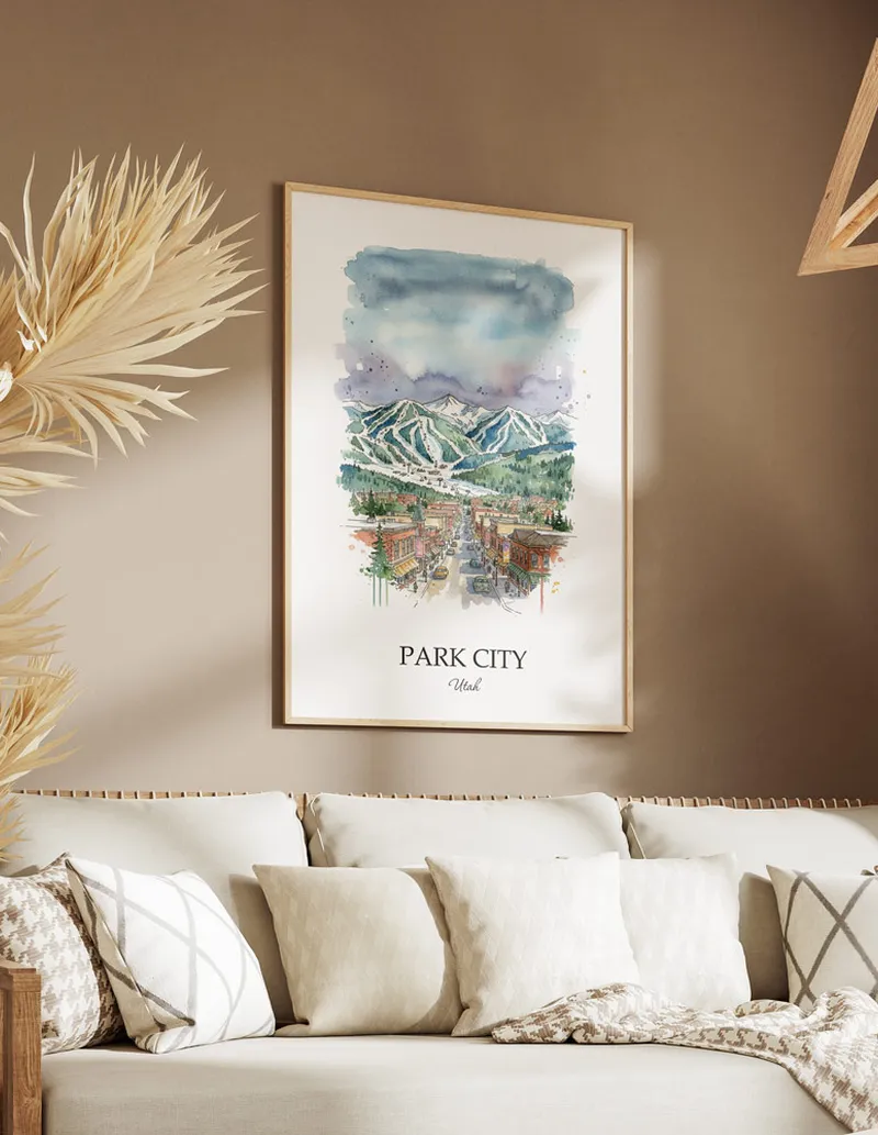 Vintage travel poster of Park City city, USA - Utah in a light frame displayed above a sofa in a bright boho interior.