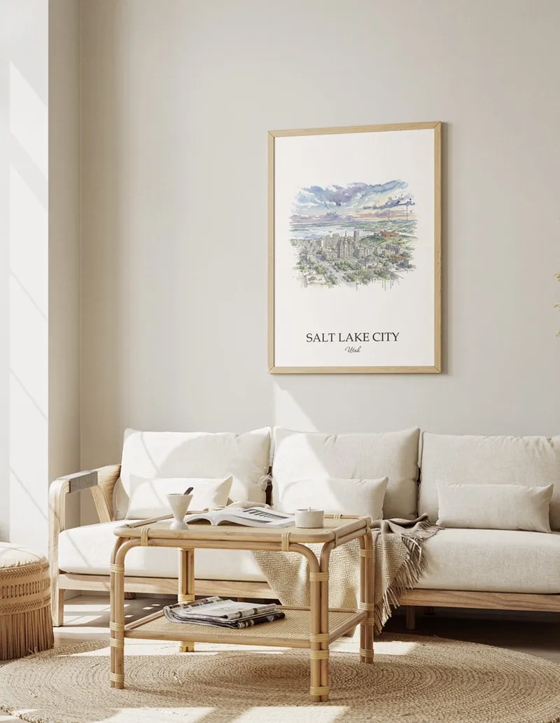 Framed wall art featuring Salt Lake City, USA - Utah in a light wood frame hanging above a sofa in a modern living room.
