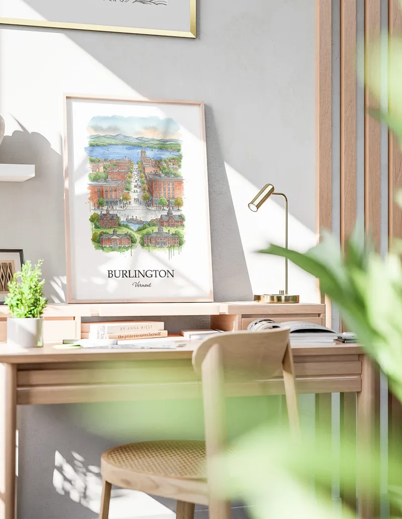 Cozy, well-lit workspace with a minimalist poster of Burlington, USA - Vermont in a light frame sitting on the desk.