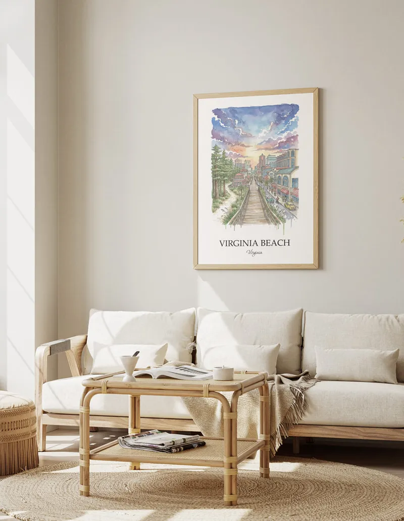 Framed wall art featuring Virginia Beach, USA - Virginia in a light wood frame hanging above a sofa in a modern living room.