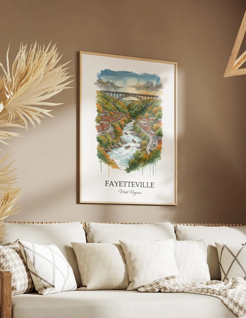 Vintage travel poster of Fayetteville city, USA - West Virginia in a light frame displayed above a sofa in a bright boho interior.