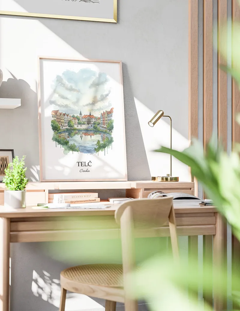 Cozy, well-lit workspace with a minimalist poster of Tel_, Czechia in a light frame sitting on the desk.