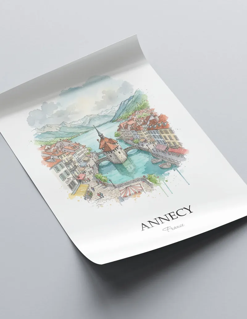 A close-up of a high-quality paper print featuring the Annecy city minimalist design.