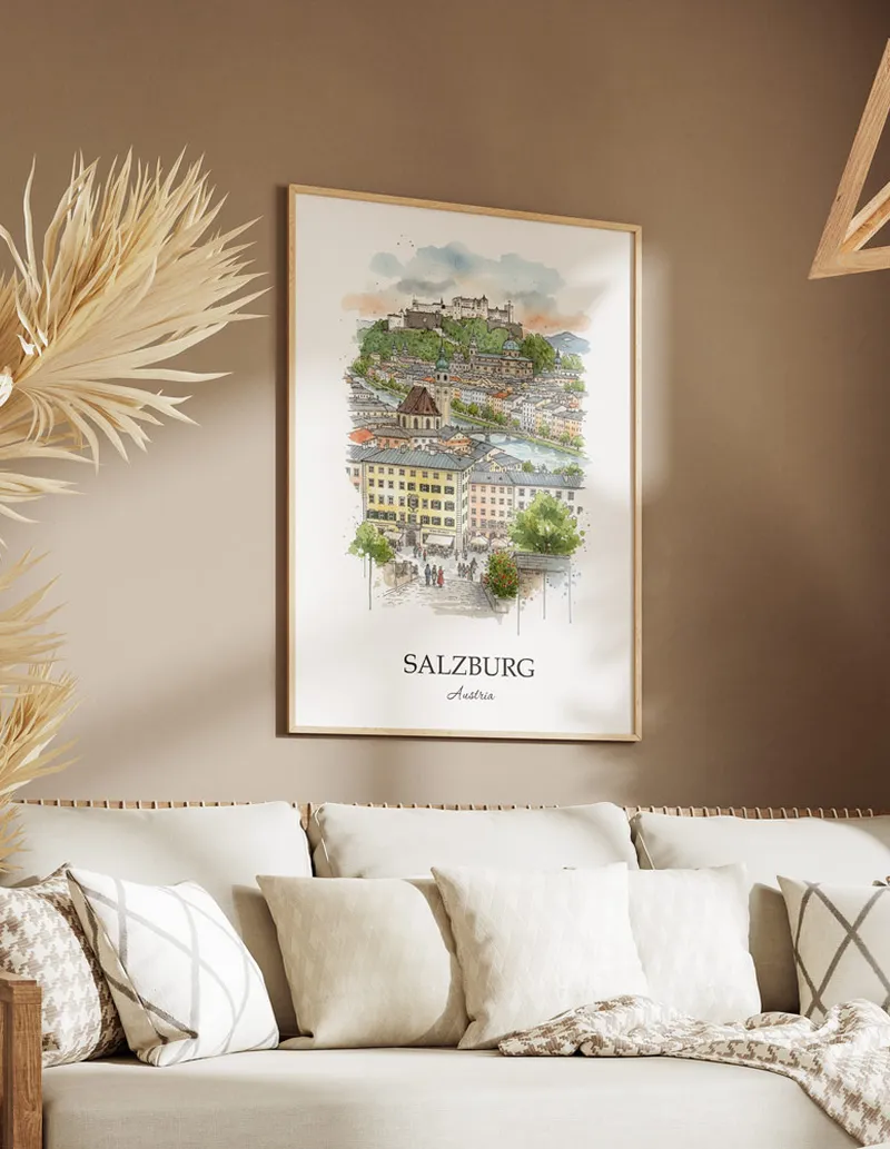 Vintage travel poster of Salzburg city, Austria in a light frame displayed above a sofa in a bright boho interior.