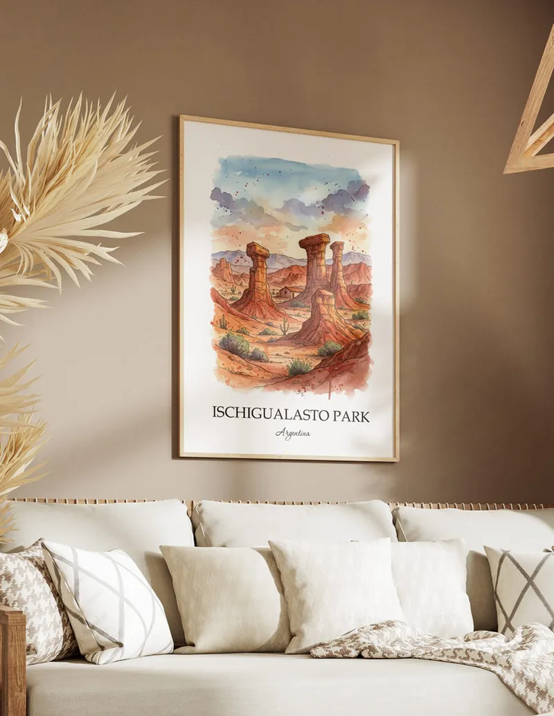 Vintage travel poster of Ischigualasto Park, Argentina in a light frame displayed above a sofa in a bright boho interior.
