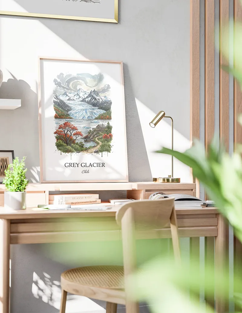 Cozy, well-lit workspace with a minimalist poster of Grey Glacier, Chile in a light frame sitting on the desk.