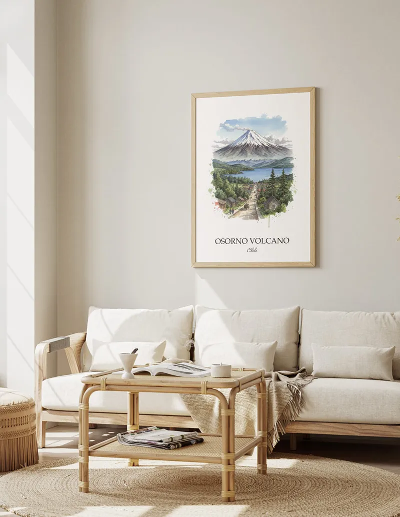 Framed wall art featuring Osorno Volcano, Chile in a light wood frame hanging above a sofa in a modern living room.