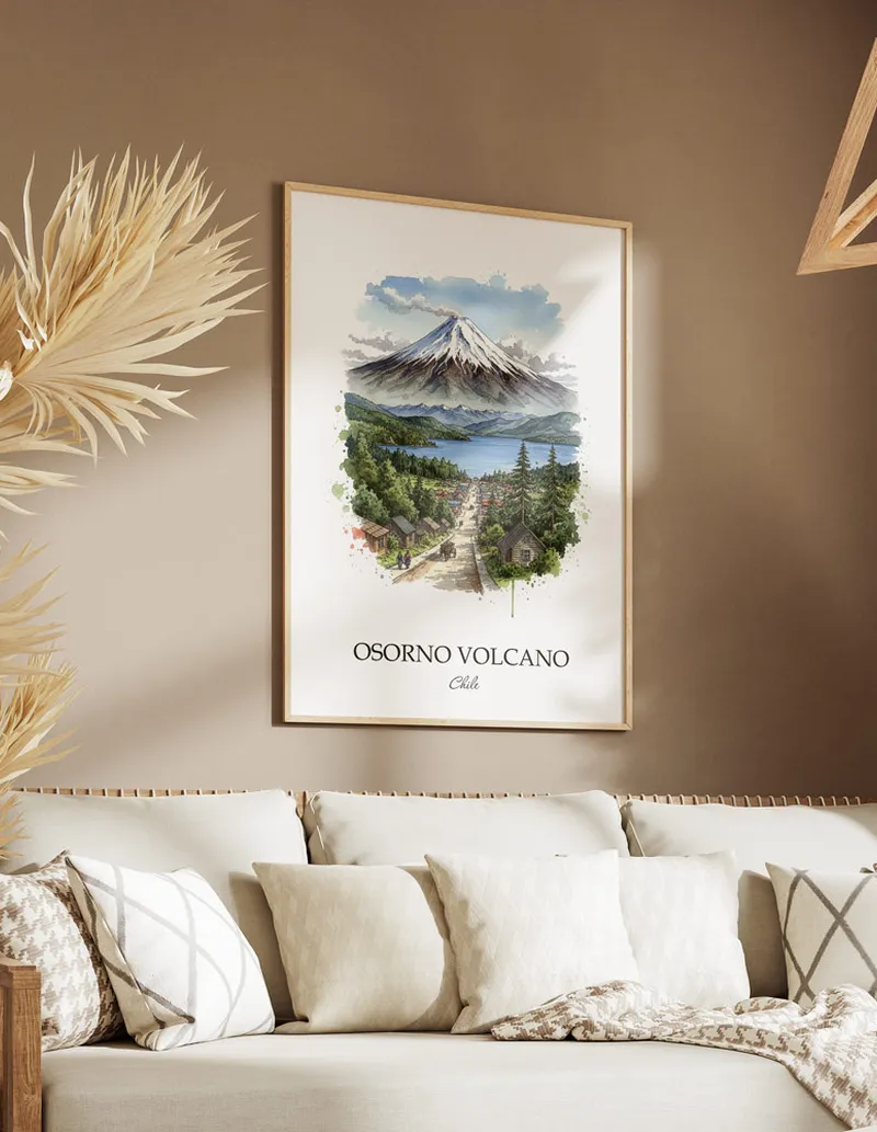 Vintage travel poster of Osorno Volcano, Chile in a light frame displayed above a sofa in a bright boho interior.
