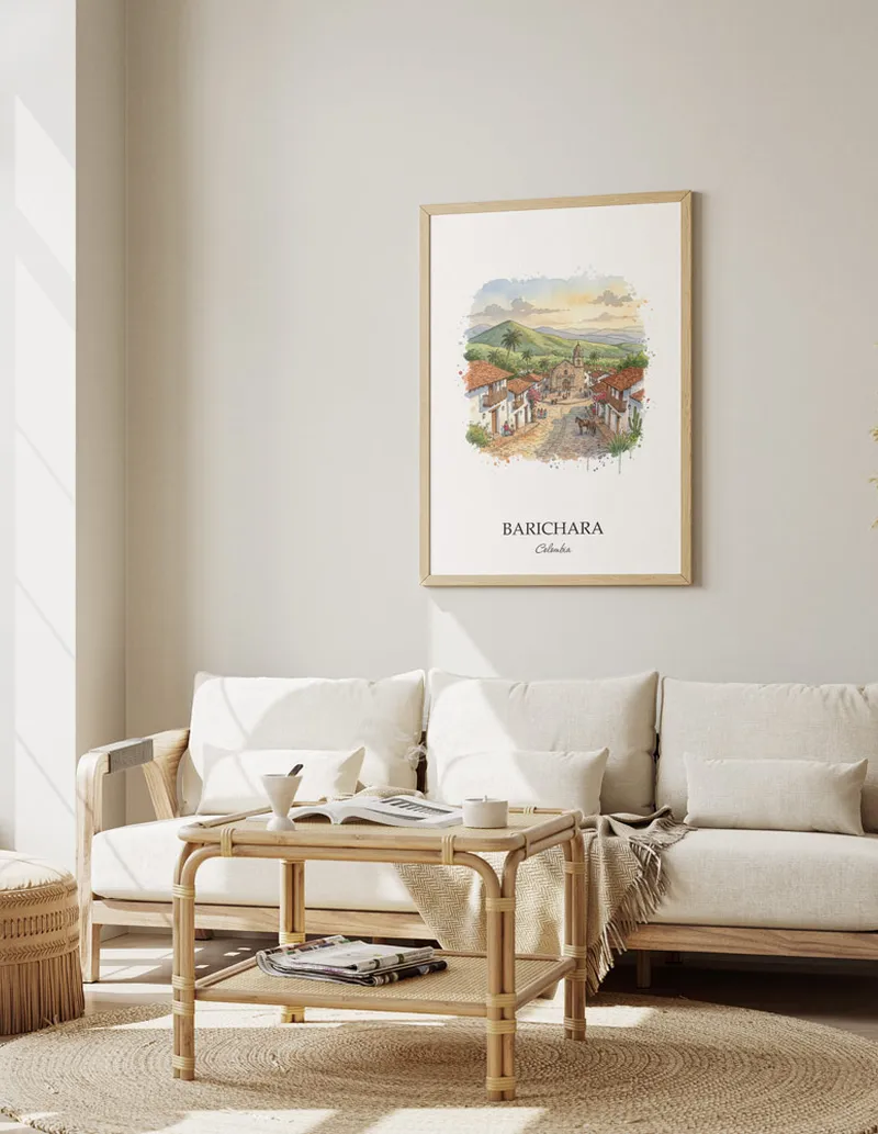 Vintage travel poster of Barichara, Colombia in a light frame displayed above a sofa in a bright boho interior.