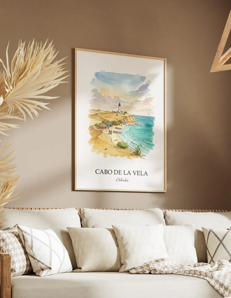 A gorgeous boho-inspired living space with a framed vintage travel poster of Cabo de la Vela in Colombia on display.