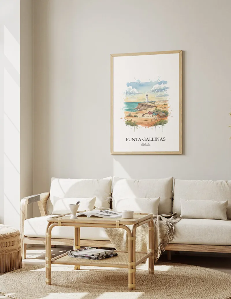 Vintage travel poster of Punta Gallinas, Colombia in a light frame displayed above a sofa in a bright boho interior.