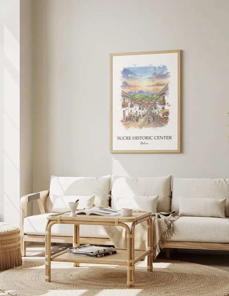 Vintage travel poster of Sucre Historic Center, Bolivia in a light frame displayed above a sofa in a bright boho interior.