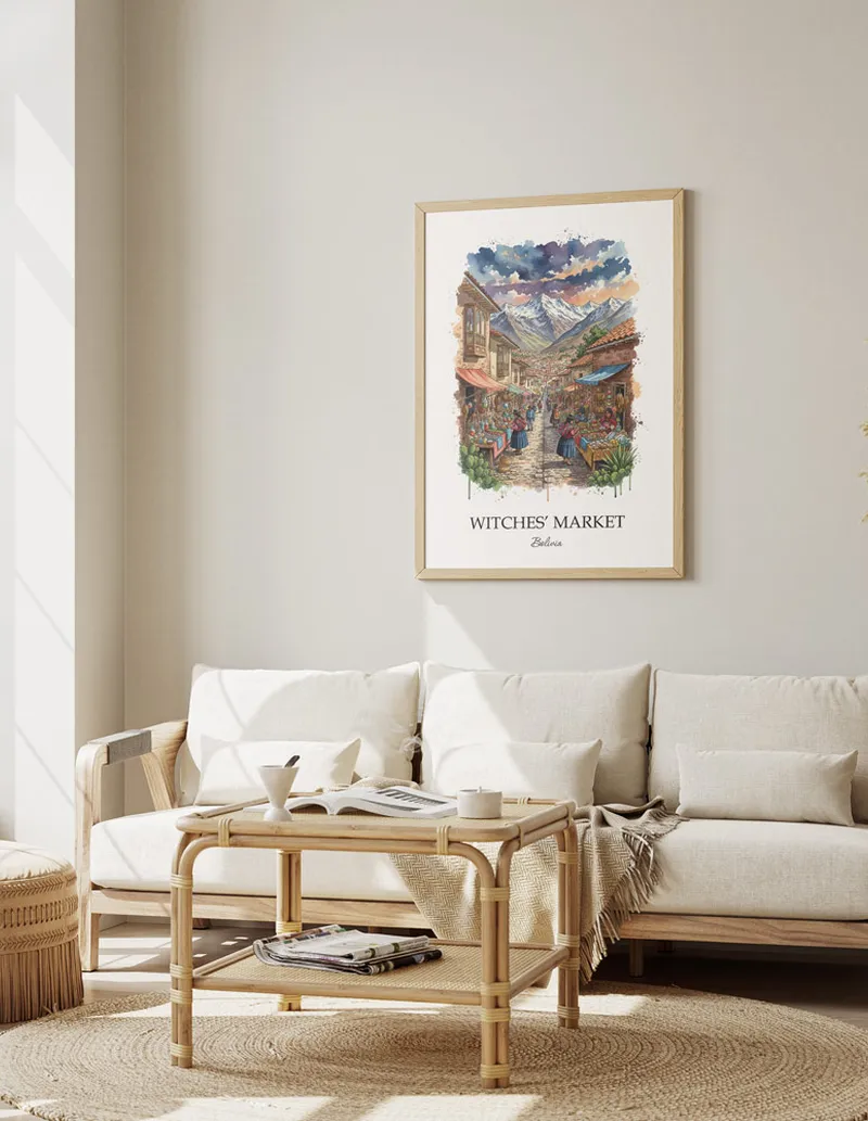 Vintage travel poster of Witches' Market, Bolivia in a light frame displayed above a sofa in a bright boho interior.
