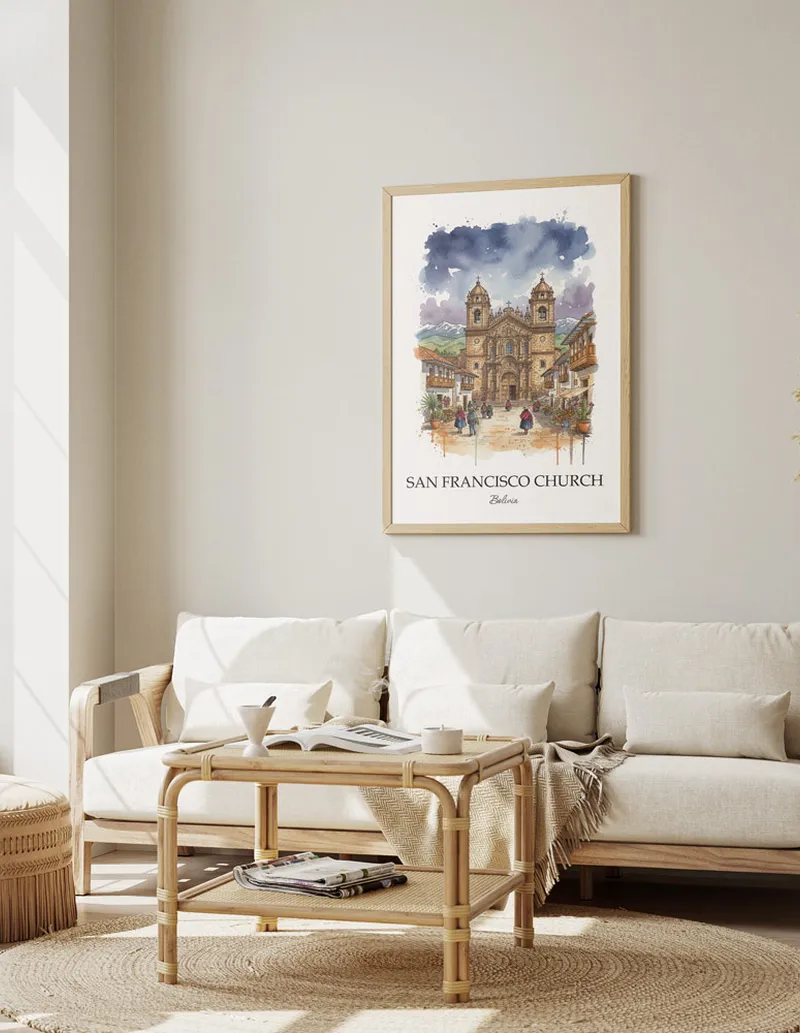 Vintage travel poster of San Francisco Church, Bolivia in a light frame displayed above a sofa in a bright boho interior.