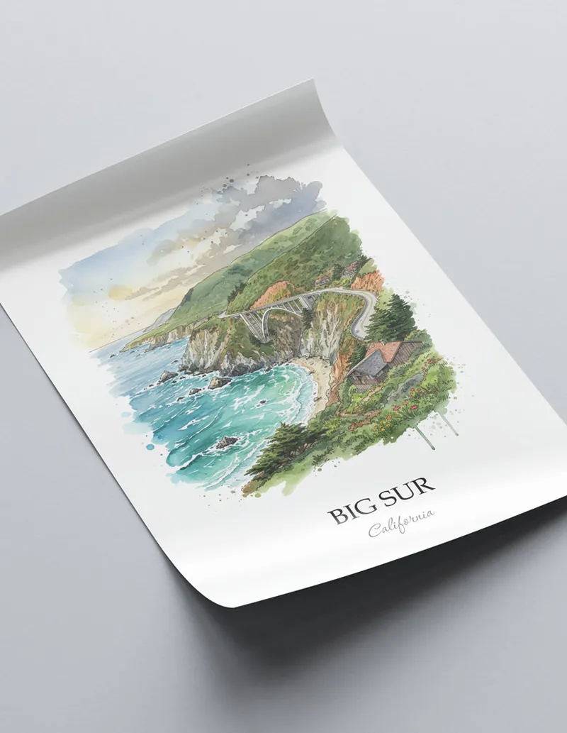 Framed wall art featuring Big Sur in California in a light wood frame leaning on the floor.