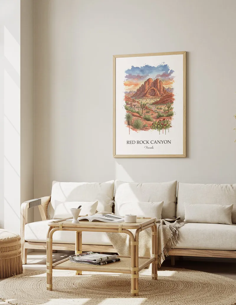 Vintage travel poster of Red Rock Canyon, Nevada in a light frame displayed above a sofa in a bright boho interior.
