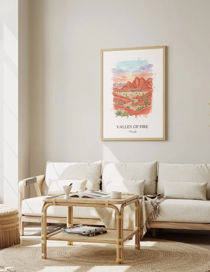Vintage travel poster of Valley of Fire, Nevada in a light frame displayed above a sofa in a bright boho interior.