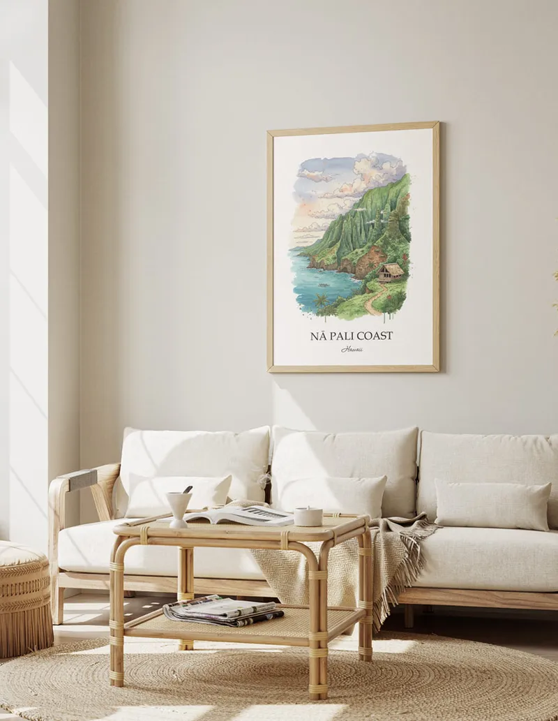 Vintage travel poster of N_ Pali Coast, Hawaii in a light frame displayed above a sofa in a bright boho interior.