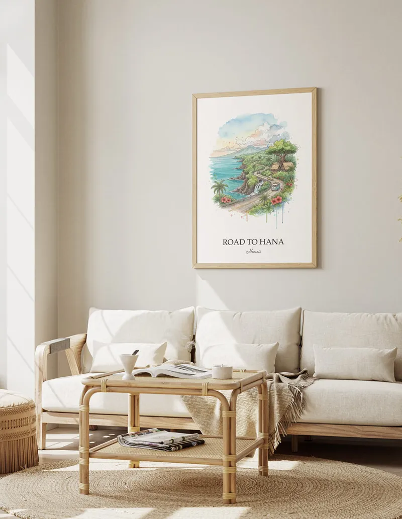 Vintage travel poster of Road to Hana, Hawaii in a light frame displayed above a sofa in a bright boho interior.