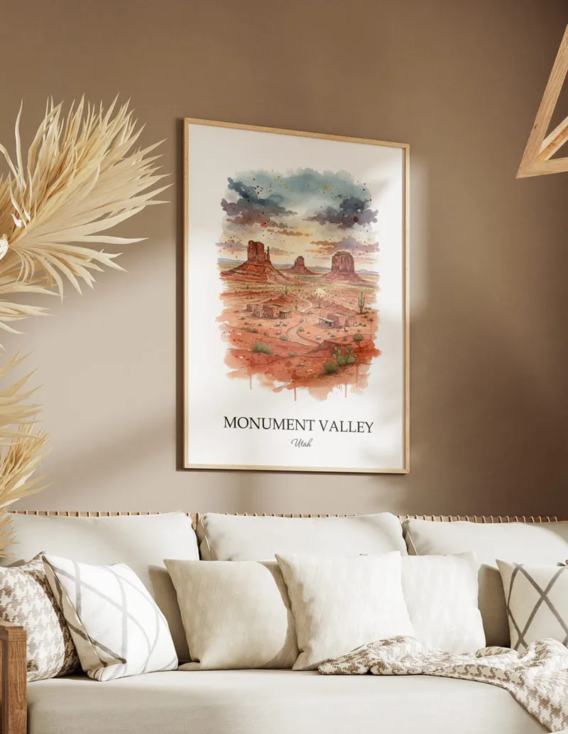 Cozy, well-lit workspace with a minimalist poster of Monument Valley, Utah in a light frame sitting on the desk.