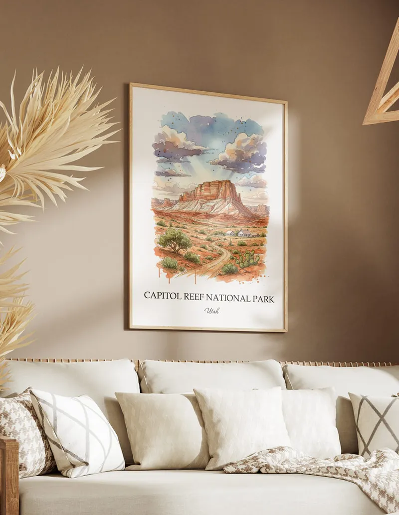 Cozy, well-lit workspace with a minimalist poster of Capitol Reef National Park, Utah in a light frame sitting on the desk.