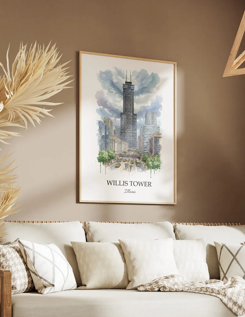 Cozy, well-lit workspace with a minimalist poster of Willis Tower, Illinois in a light frame sitting on the desk.