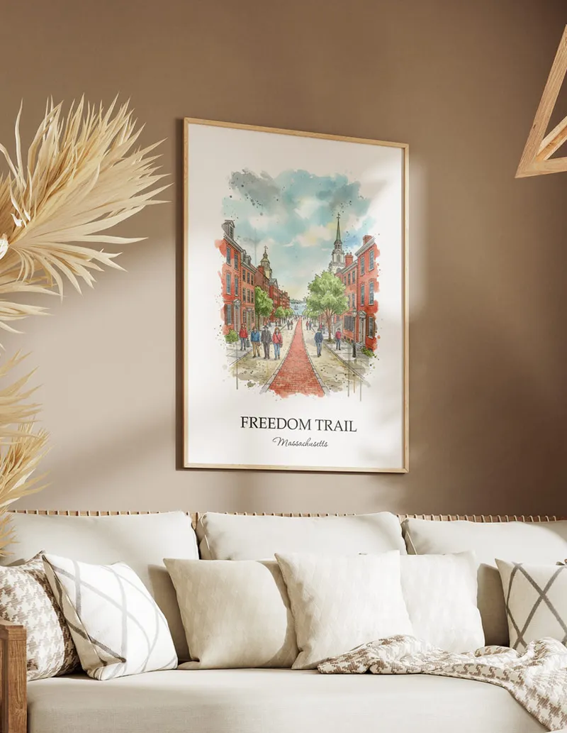 Cozy, well-lit workspace with a minimalist poster of Freedom Trail, Massachusetts in a light frame sitting on the desk.