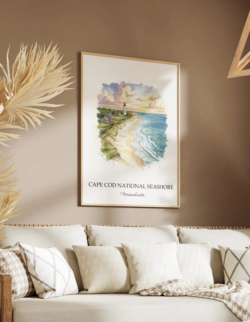 Cozy, well-lit workspace with a minimalist poster of Cape Cod National Seashore, Massachusetts in a light frame sitting on the desk.