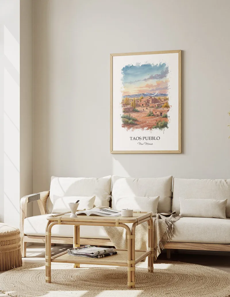 A gorgeous boho-inspired living space with a framed vintage travel poster of Taos Pueblo in New Mexico on display.