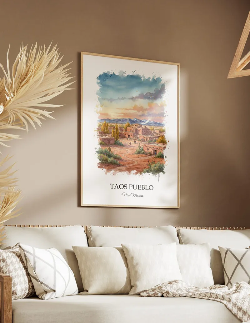 Cozy, well-lit workspace with a minimalist poster of Taos Pueblo, New Mexico in a light frame sitting on the desk.