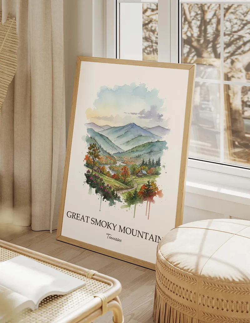 Vintage travel poster of Great Smoky Mountains, Tennessee in a light frame displayed above a sofa in a bright boho interior.