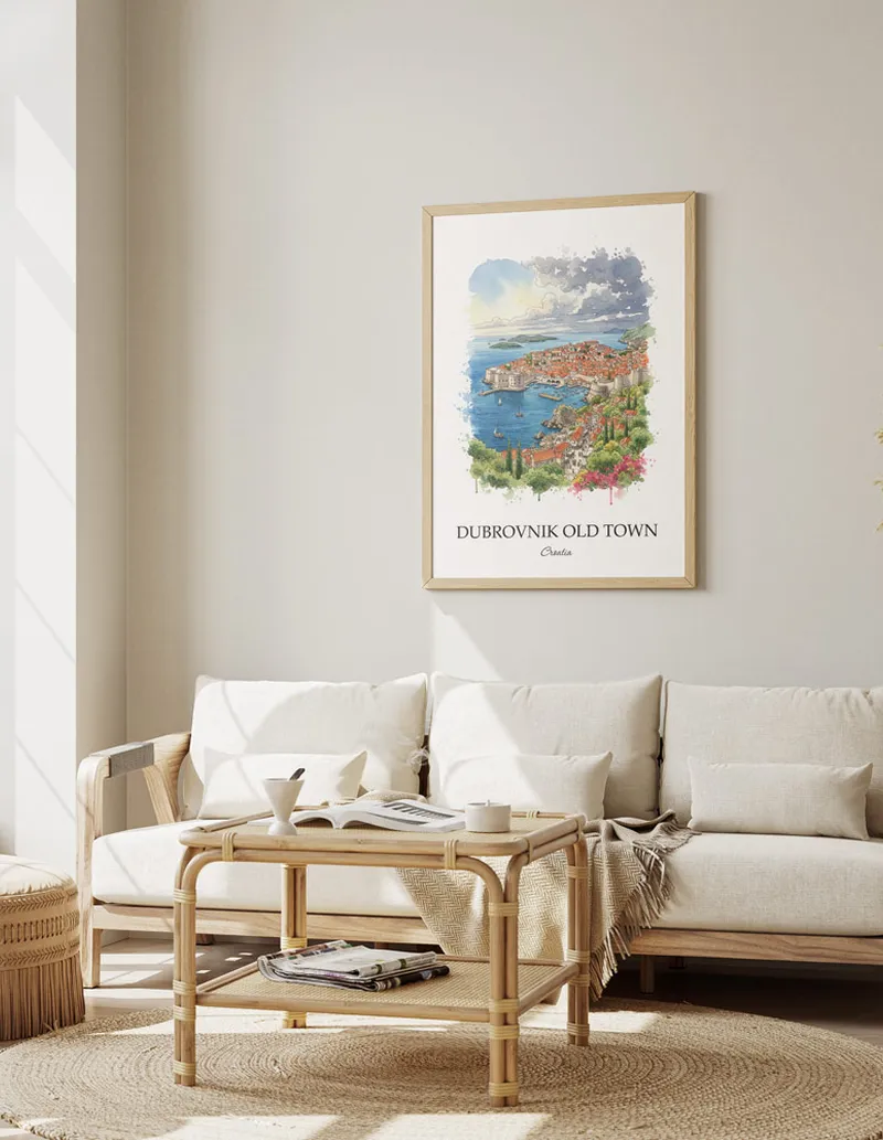 Framed wall art featuring Dubrovnik Old Town, Croatia in a light wood frame hanging above a sofa in a modern living room.