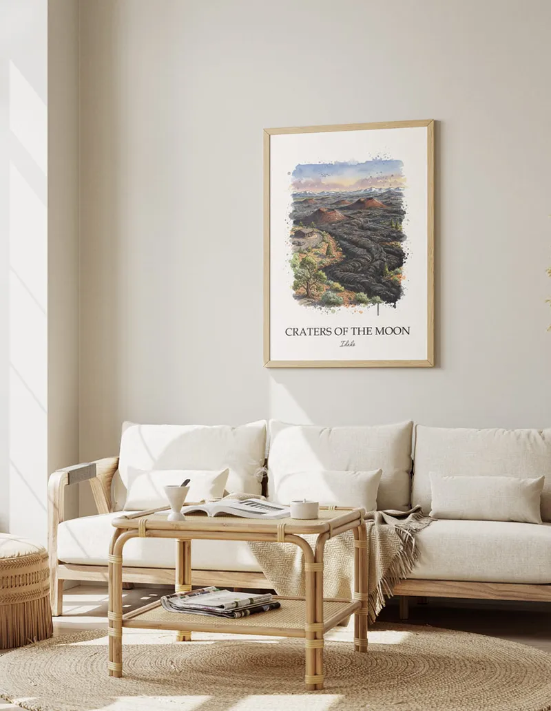 A gorgeous boho-inspired living space with a framed vintage travel poster of Craters of the Moon in Idaho on display.