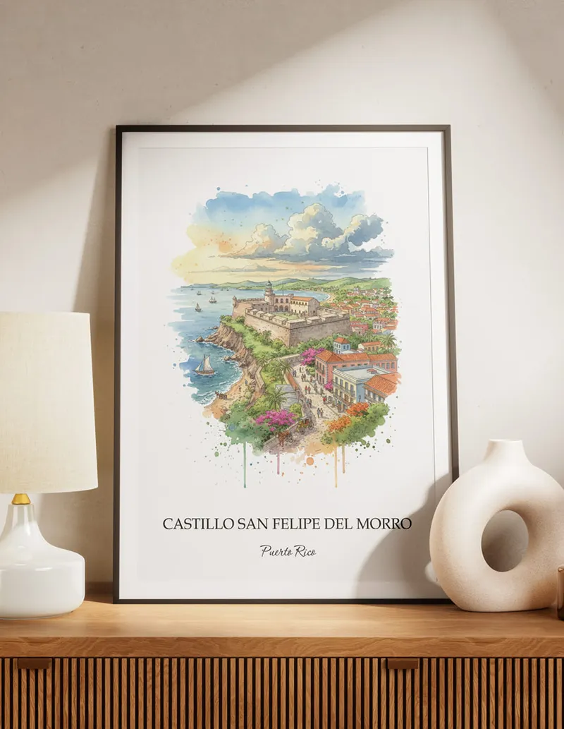 Framed wall art featuring Castillo San Felipe del Morro, Puerto Rico in a light wood frame hanging above a sofa in a modern living room.