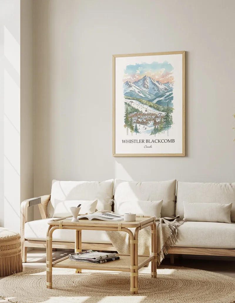A gorgeous boho-inspired living space with a framed vintage travel poster of Whistler Blackcomb in Canada on display.