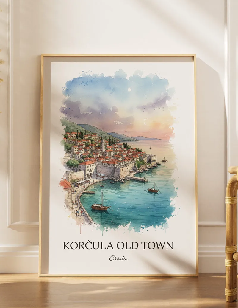 Framed wall art featuring Kor_ula Old Town in Croatia in a light wood frame leaning on the floor.