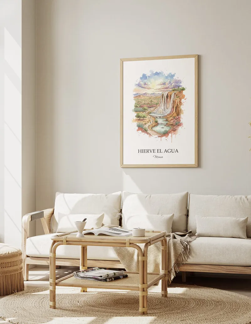 Cozy, well-lit workspace with a minimalist poster of Hierve el Agua, Mexico in a light frame sitting on the desk.
