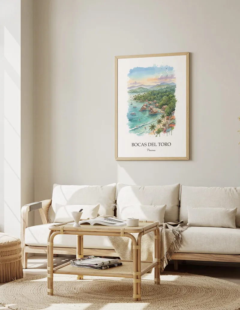 Cozy, well-lit workspace with a minimalist poster of Bocas del Toro, Panama in a light frame sitting on the desk.