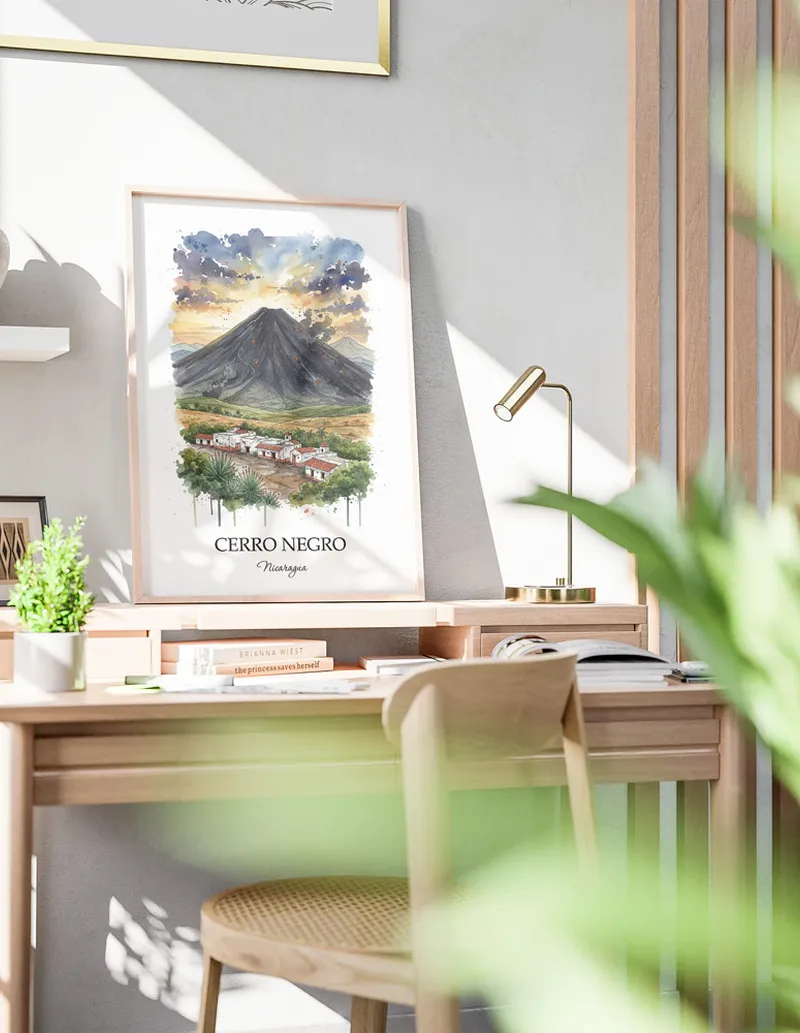 Framed wall art featuring Cerro Negro in Nicaragua in a light wood frame leaning on the floor.
